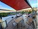 Rooftop deck with shade, outdoor dining, lounge chairs, and mountain views at 4730 W Moncrieff Pl, Denver, CO 80212