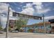 Street view in Highland Square with an art walk sign and colorful murals at 4730 W Moncrieff Pl, Denver, CO 80212