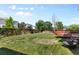 Expansive backyard view with a wooden deck, lawn, privacy fence, and neighborhood homes at 10295 Ravenswood Ln, Highlands Ranch, CO 80130
