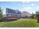 Spacious backyard view with a wooden deck, lawn, and privacy fence at 10295 Ravenswood Ln, Highlands Ranch, CO 80130