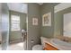 Half bathroom with modern fixtures, including vanity, framed artwork, and stylish tile flooring at 10295 Ravenswood Ln, Highlands Ranch, CO 80130