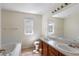 Well-lit bathroom with a soaking tub, double sinks, and modern vanity, perfect for relaxation at 10295 Ravenswood Ln, Highlands Ranch, CO 80130