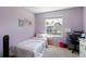 Bright bedroom with large window and soft pink accents, a comfortable and serene space at 10295 Ravenswood Ln, Highlands Ranch, CO 80130
