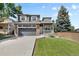 Charming two-story home with a well-maintained lawn, attached garage, and inviting front porch at 10295 Ravenswood Ln, Highlands Ranch, CO 80130