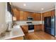 Functional kitchen layout featuring wood cabinetry, stainless steel appliances, and hardwood floors at 10295 Ravenswood Ln, Highlands Ranch, CO 80130