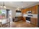 Well-lit kitchen with wood cabinets, stainless steel appliances, and access to the outdoor deck at 10295 Ravenswood Ln, Highlands Ranch, CO 80130