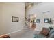 Inviting open-concept living area with staircase and large windows offering natural light at 10295 Ravenswood Ln, Highlands Ranch, CO 80130