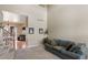 Spacious living room featuring high ceilings, a comfortable sofa, and views into the kitchen at 10295 Ravenswood Ln, Highlands Ranch, CO 80130