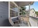 Inviting covered porch with seating offers a cozy outdoor relaxation space and neighborhood views at 10295 Ravenswood Ln, Highlands Ranch, CO 80130