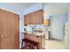 Functional kitchen with breakfast bar, wooden cabinets, and convenient access to the backyard at 1325 S Idalia St, Aurora, CO 80017