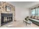 Inviting living room with stone fireplace, plush seating, and a bright, airy ambiance at 1325 S Idalia St, Aurora, CO 80017