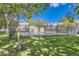 View of a fenced community pool area with shade trees and lawn at 1325 S Idalia St, Aurora, CO 80017