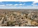 Aerial view showing the neighborhood and the Denver skyline in the distance at 6616 Zinnia St, Arvada, CO 80004