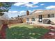 Manicured backyard with fenced in lawn, seating area and BBQ at 6616 Zinnia St, Arvada, CO 80004