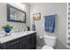 Bathroom features an elegant vanity, lighting and wall mirror at 6616 Zinnia St, Arvada, CO 80004
