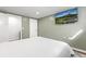 Clean bedroom features a TV, white doors and white bed linens at 6616 Zinnia St, Arvada, CO 80004