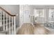 Inviting entryway featuring wood-like floors, stairs, and a front door with decorative glass at 6616 Zinnia St, Arvada, CO 80004