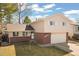 Charming home with a well-maintained lawn, brick accents, and an attached two-car garage at 6616 Zinnia St, Arvada, CO 80004