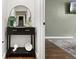 Hallway niche with black console table, decorations, and modern mirror at 6616 Zinnia St, Arvada, CO 80004