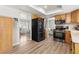 Well-lit kitchen featuring wood cabinets and stainless-steel appliances with an adjacent dining area at 6616 Zinnia St, Arvada, CO 80004