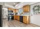 Functional kitchen space with light wood cabinets, stainless steel appliances, and ample counter space at 6616 Zinnia St, Arvada, CO 80004