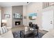 Cozy living room with a brick fireplace, high ceilings, and a comfortable seating arrangement at 6616 Zinnia St, Arvada, CO 80004