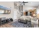 Spacious living room with a TV, stairs, and a view to the kitchen beyond at 6616 Zinnia St, Arvada, CO 80004