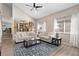 Bright living room with vaulted ceilings, wood-like floors, and a view into the adjacent kitchen at 6616 Zinnia St, Arvada, CO 80004