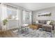 Bright living room with large windows, stylish decor, and comfortable seating arrangement at 6616 Zinnia St, Arvada, CO 80004