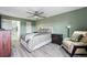 Spacious bedroom featuring a ceiling fan, a sitting area, and a view into the bathroom at 13850 E Marina Dr # 606, Aurora, CO 80014