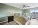 Comfortable bedroom with a large window, ceiling fan, and a cozy chair at 13850 E Marina Dr # 606, Aurora, CO 80014
