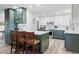 Updated kitchen with white upper and gray lower cabinets, stainless steel appliances, and a breakfast bar at 13850 E Marina Dr # 606, Aurora, CO 80014