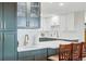 Kitchen features white cabinets, green island, bar seating, and stainless steel hardware at 13850 E Marina Dr # 606, Aurora, CO 80014