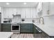 Modern kitchen with stainless steel appliances, white cabinets, and updated fixtures at 13850 E Marina Dr # 606, Aurora, CO 80014
