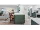Charming kitchen island with white countertop and green cabinets open to the cozy living room at 13850 E Marina Dr # 606, Aurora, CO 80014