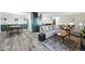 Spacious living area with gray wood-look floors, comfortable seating, and a modern kitchen at 13850 E Marina Dr # 606, Aurora, CO 80014