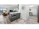 Open living area with updated kitchen featuring an island with seating and modern appliances at 13850 E Marina Dr # 606, Aurora, CO 80014