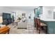 Open-concept living room featuring wood-look floors, comfortable seating, and a modern kitchen with a breakfast bar at 13850 E Marina Dr # 606, Aurora, CO 80014