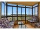 Cozy sunroom with floor-to-ceiling windows and comfortable seating overlooking the neighborhood at 13850 E Marina Dr # 606, Aurora, CO 80014