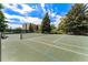 Well-maintained tennis court with blue and green surface and surrounding mature trees at 13850 E Marina Dr # 606, Aurora, CO 80014