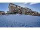 Large backyard with snow, showing home's back elevation and deck at 14461 Mosaic Ave, Parker, CO 80134