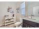 Powder room with white vanity, toilet, and decorative wall art at 14461 Mosaic Ave, Parker, CO 80134