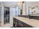 Main bathroom with double vanity, quartz countertop, and walk-in shower at 14461 Mosaic Ave, Parker, CO 80134