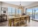 Bright dining room with a large table, access to a deck, and natural light at 14461 Mosaic Ave, Parker, CO 80134