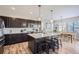 Spacious kitchen with dark cabinetry, quartz countertops, and an island at 14461 Mosaic Ave, Parker, CO 80134