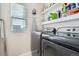 Functional laundry room with washer, dryer, and shelving at 14461 Mosaic Ave, Parker, CO 80134