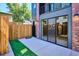 Modern home featuring a quaint patio area with turf and fenced yard for privacy at 1821 N Grove St, Denver, CO 80204