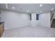 Spacious finished basement with neutral carpet, modern lighting, and staircase access at 1821 N Grove St, Denver, CO 80204