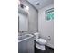 Modern powder bathroom featuring a unique concrete sink, updated fixtures, and neutral colors at 1821 N Grove St, Denver, CO 80204