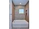 Well-lit bathroom with a soaking tub and shower combo at 1821 N Grove St, Denver, CO 80204